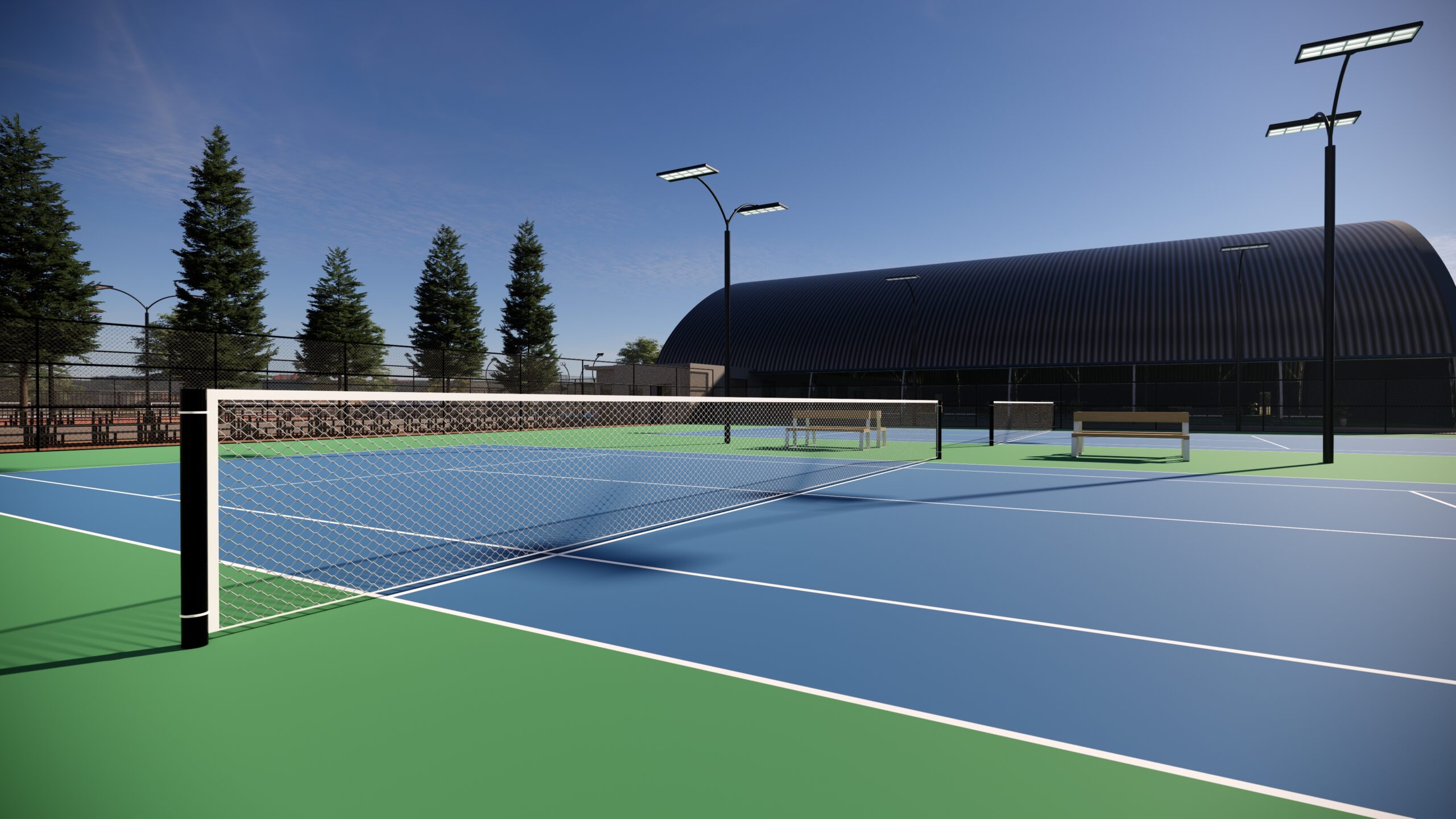 Luxury Outdoor Living An empty outdoor tennis court with blue and green surfaces, surrounded by fences, tall lights, trees, and a large curved building in the background under a clear sky—an ideal setting for luxury outdoor living. Toronto Contractors